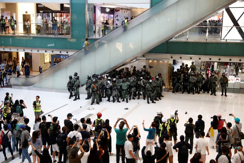 Shoppers and anti-government protesters gather at New Town Plaza in Sha Tin, Hong Kong