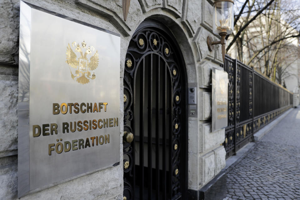 FILE- in this March 27, 2018 file photo a sign reading 'Emabassy of the Russian Federation' displayed at entrance of the Russian embassy in Berlin, Germany. Germany said Thursday it is seeking EU sanctions against a Russian man over his alleged role in the hacking of the German parliament at a time when evidence shows he was working for Russian intelligence. Germany’s Foreign Ministry said it called in Russian ambassador Sergei Nechayev to inform him in person of the move. (AP Photo/Markus Schreiber)