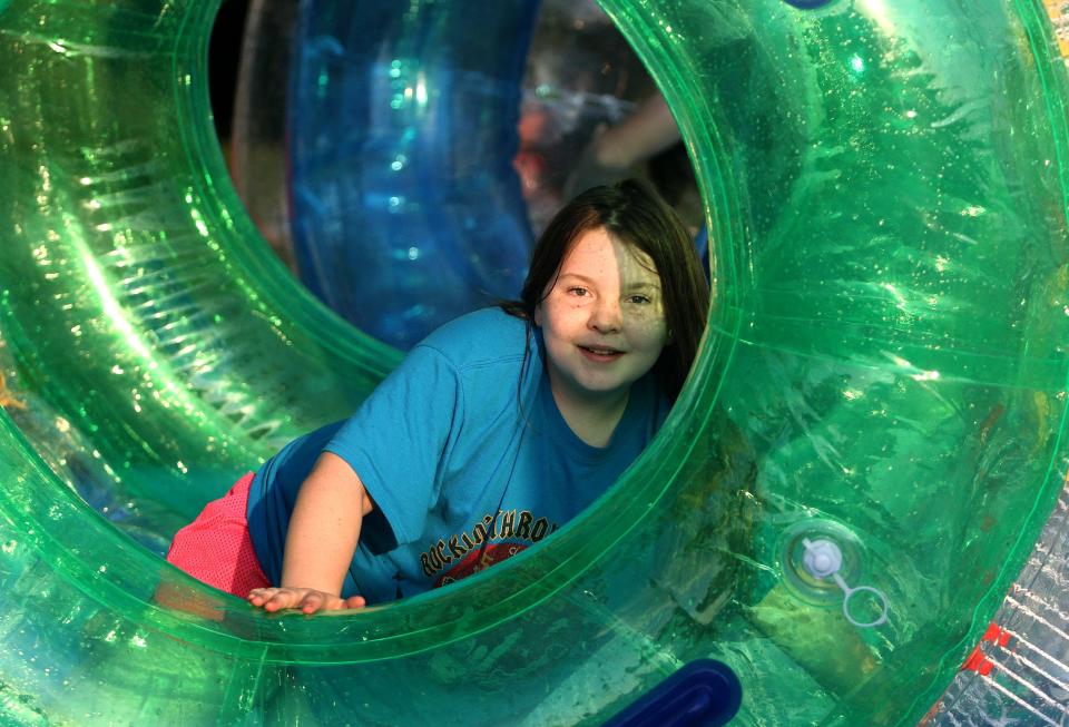 Adley Winland plays in a blow-up tube at Strawberry Fest in Portland on Saturday, May 14, 2022.