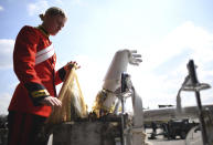 A member of the Household Cavalry, The Life Guards preparing her uniform before rehearsing for Britain's Prince Philip's funeral on the Drill Square at the Army Training Centre Pirbright in Woking, Surrey, England Wednesday April 14, 2021. Prince Philip's funeral will be held at Windsor Castle on Saturday following his death at the age of 99 on April 10. (Victoria Jones/PA via AP)