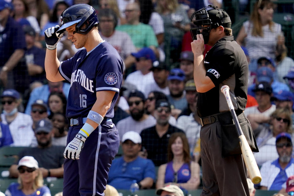 Chicago Cubs' Patrick Wisdom, left, throws his bat after being called out on strikes during the fourth inning of a baseball game against the San Francisco Giants in Chicago, Friday, Sept. 10, 2021. (AP Photo/Nam Y. Huh)