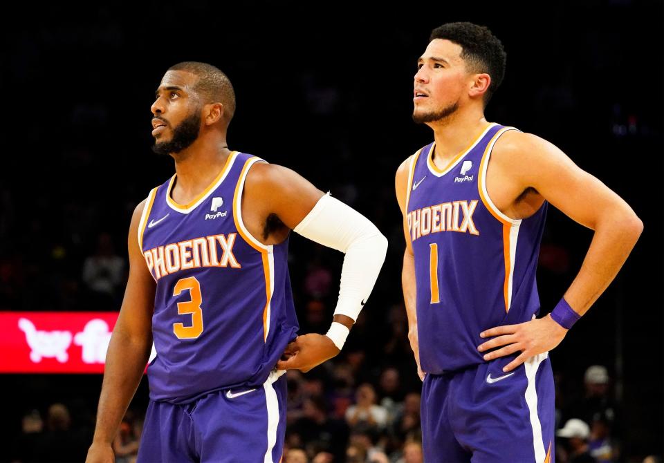 Nov 4, 2021; Phoenix, Arizona, USA; Phoenix Suns guard Chris Paul (3) and guard Devin Booker (1) against the Houston Rockets in the second half at Footprint Center. Mandatory Credit: Rob Schumacher-Arizona Republic