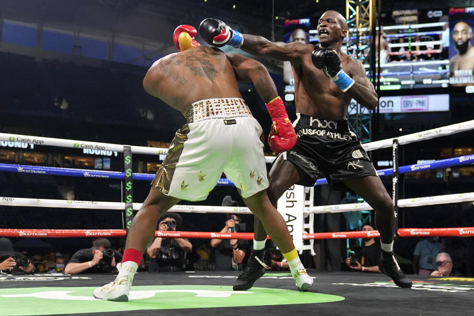 Former NFL wide receiver Chad Johnson, right, fights Brian Maxwell during an exhibition boxing match at Hard Rock Stadium, Sunday, June 6, 2021, in Miami Gardens, Fla. (AP Photo/Lynne Sladky)