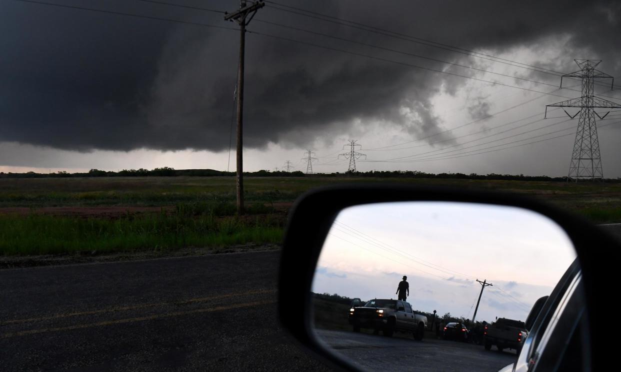 <span>People watch the progress of a storm along in Texas between Abilene and Hawley on 2 May.</span><span>Photograph: Ronald W Erdrich/AP</span>