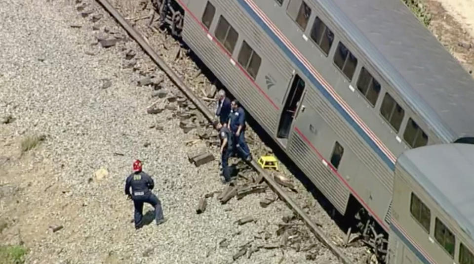 Emergency personnel respond to the scene after an Amtrak passenger train derailed after striking a vehicle on Wednesday, June 28, 2023 in Moorpark, Calif. Three of the trains seven cars carrying 190 passengers went off the tracks following the collision said Ventura County Fire Department Captain Brian McGrath. (KABC-7 via AP)