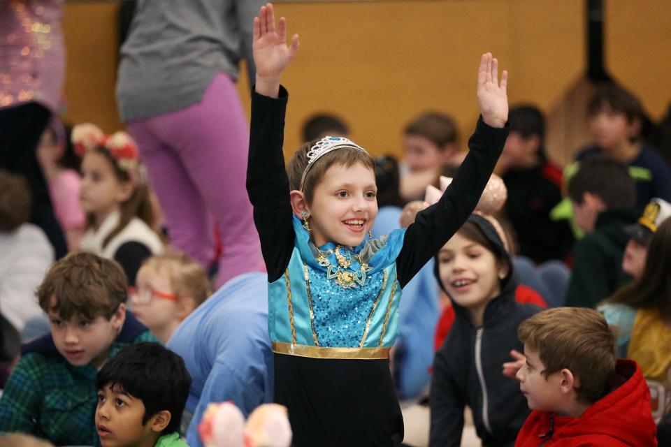 Sammy LeClair waves at a Dondero School lunch staff member before the Make-A-Wish presentation on Friday, Jan. 13, 2023 in Portsmouth.