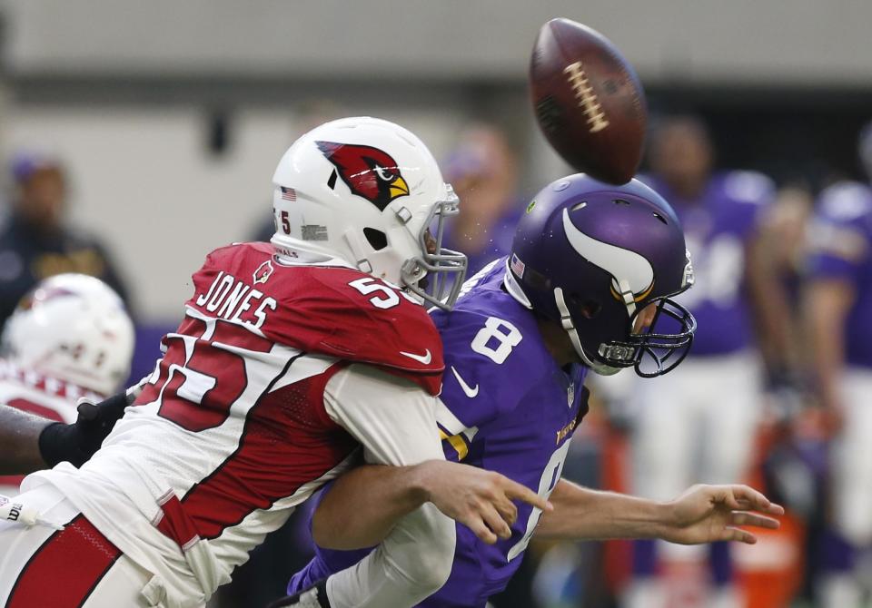 FILE - In this Nov. 20, 2016, file photo, Arizona Cardinals outside linebacker Chandler Jones, left, hits Minnesota Vikings quarterback Sam Bradford as he tries to pass during the second half of an NFL football game, in Minneapolis. The Cardinals have placed a non-exclusive franchise tag on outside linebacker Chandler Jones after failing to reach a long-term deal with the player. The "non-exclusive" tag allows the Cardinals to continue negotiating with Jones through July 15. (AP Photo/Jim Mone, File)