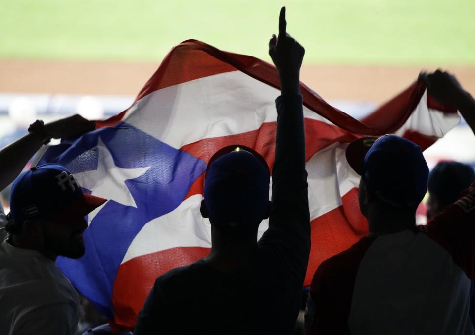 Fans for Puerto Rico react during the eighth inning of a second-round World Baseball Classic game against the Dominican Republic on Tuesday, March 14, 2017, in San Diego. (AP Photo/Gregory Bull)