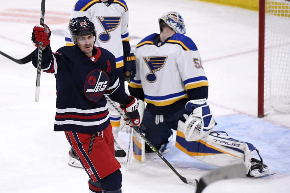 Winnipeg Jets' Mark Scheifele (55) celebrates his goal against St. Louis Blues goaltender Jordan Binnington (50) during the second period of NHL hockey game action in Winnipeg, Manitoba, Sunday, Dec. 19, 2021. (Fred Greenslade/The Canadian Press via AP)