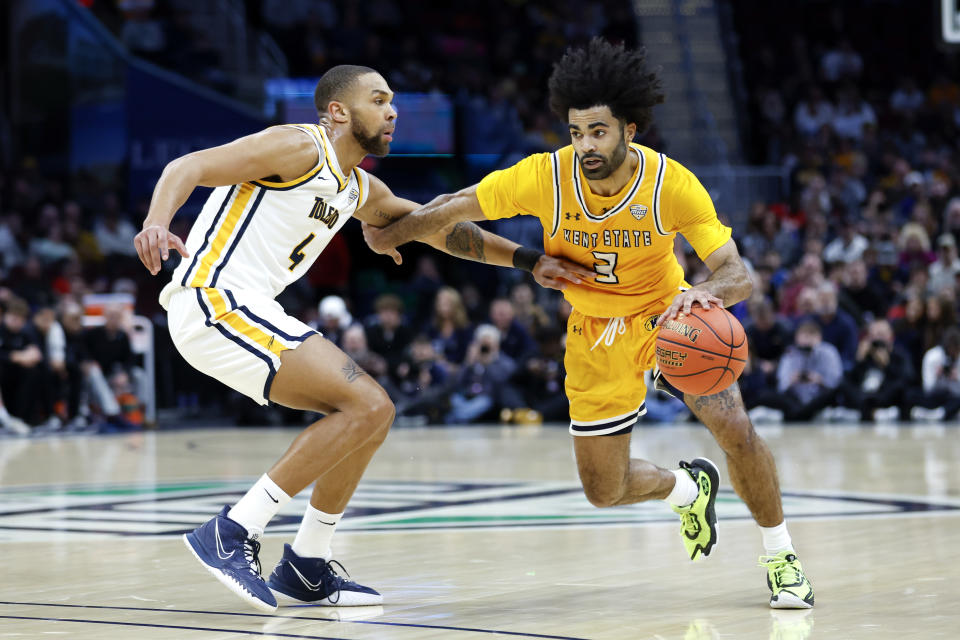 Kent State guard Sincere Carry (3) drives against Toledo forward Setric Millner Jr. (4) during the first half of an NCAA college basketball game for the championship of the Mid-American Conference tournament, Saturday, March 11, 2023, in Cleveland. (AP Photo/Ron Schwane)