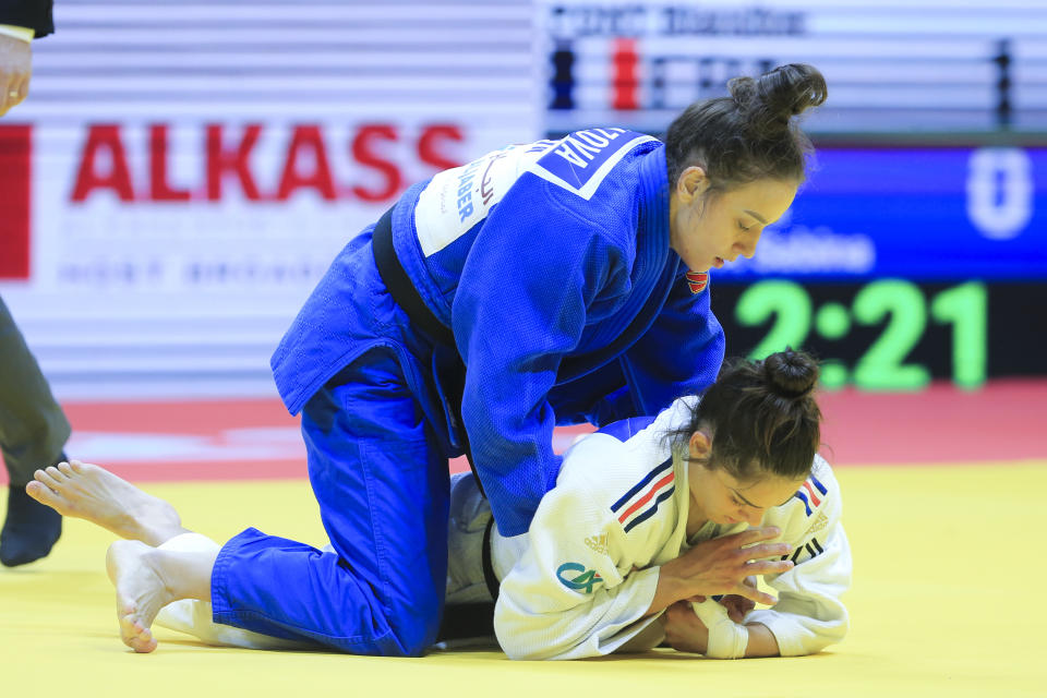 CORRECTS THAT SABINA GILIAZOVA IS ON TOP - Sabina Giliazova of Russia and Blandine Pont of France, bottom, in action during the women's -48 category at the World Judo Championships in Doha, Qatar, Sunday, April 5, 2023. (AP Photo/Hussein Sayed)