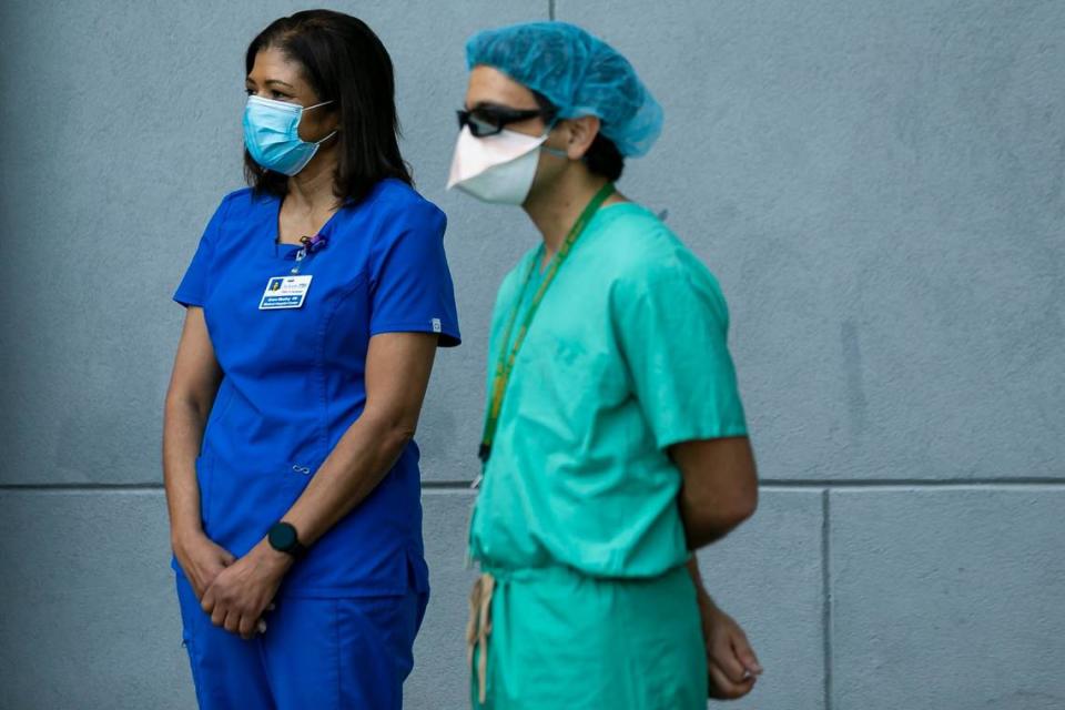 From left, ICU Nurse Grace Meatley and Dr. David De La Zerda attend a press conference outside of Jackson Memorial Hospital in Miami, Florida, on Tuesday, Dec. 15, 2020. The conference was held after Jackson Memorial Hospital administered doses of Pfizer-BioNTech COVID-19 vaccine to its healthcare workers.