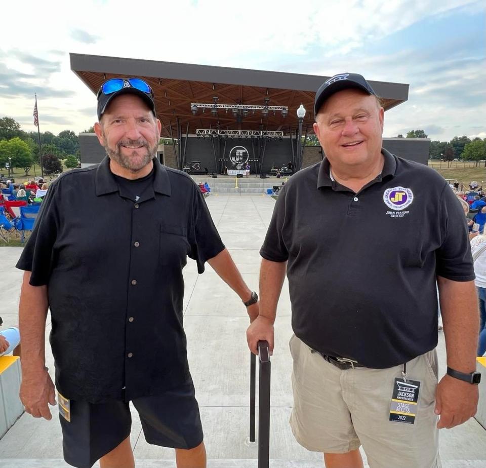 Randy Gonzaelz, Jackson Township fiscal officer and economic development director, left, and John Pizzino, township trustee, are shown at Saturday's amphitheater concert.