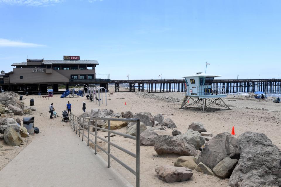 Beachgoers use the playground near the Ventura Pier on July 17.