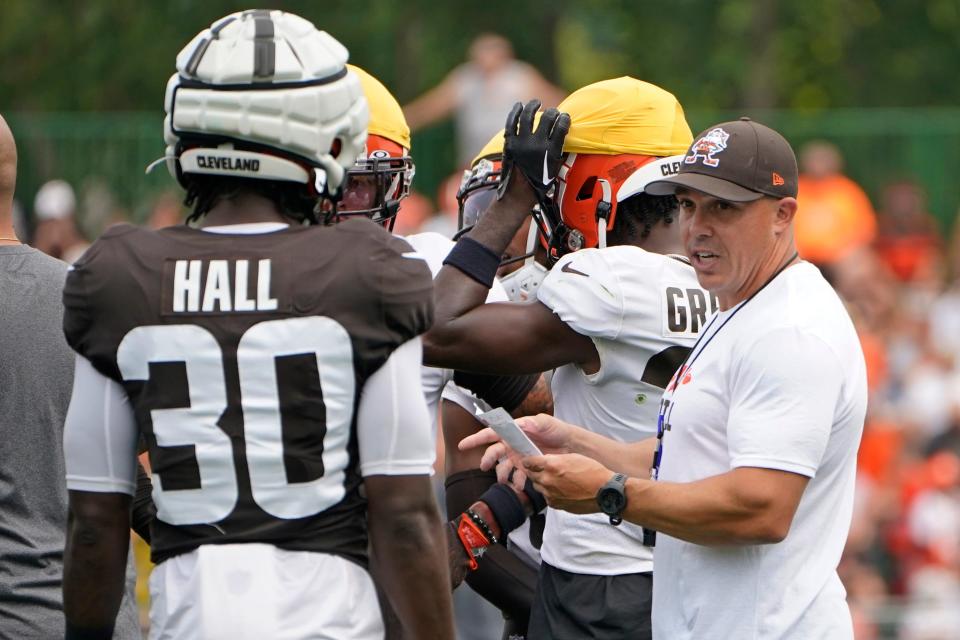 Cleveland Browns assistant head coach/special teams coordinator Bubba Ventrone, right, talks with running back Hassan Hall (30) on Aug. 1 in Berea.