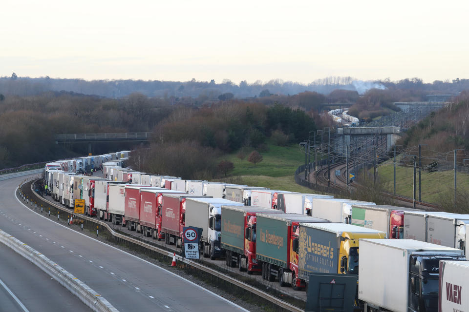 Freight lorries lined up on the M20 near Ashford, Kent, where hundreds of travellers are spending Christmas Day as they wait to resume their journey to the Port of Dover and across The Channel now that the borders with France have reopened. (Photo by Gareth Fuller/PA Images via Getty Images)