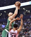 Toronto Raptors guard Fred VanVleet (23) picks up a foul on Boston Celtics forward Aron Baynes (46) as he drives to the basket during the first half of an NBA basketball game, Friday, Oct. 19, 2018 in Toronto. (Frank Gunn/The Canadian Press via AP)