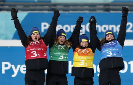 Biathlon - Pyeongchang 2018 Winter Olympics - Women's 4x6 km Relay Final - Alpensia Biathlon Centre - Pyeongchang, South Korea - February 22, 2018 - Silver medalists Linn Persson, Mona Brorsson, Anna Magnusson and Hanna Oeberg of Sweden celebrate during the victory ceremony. REUTERS/Murad Sezer