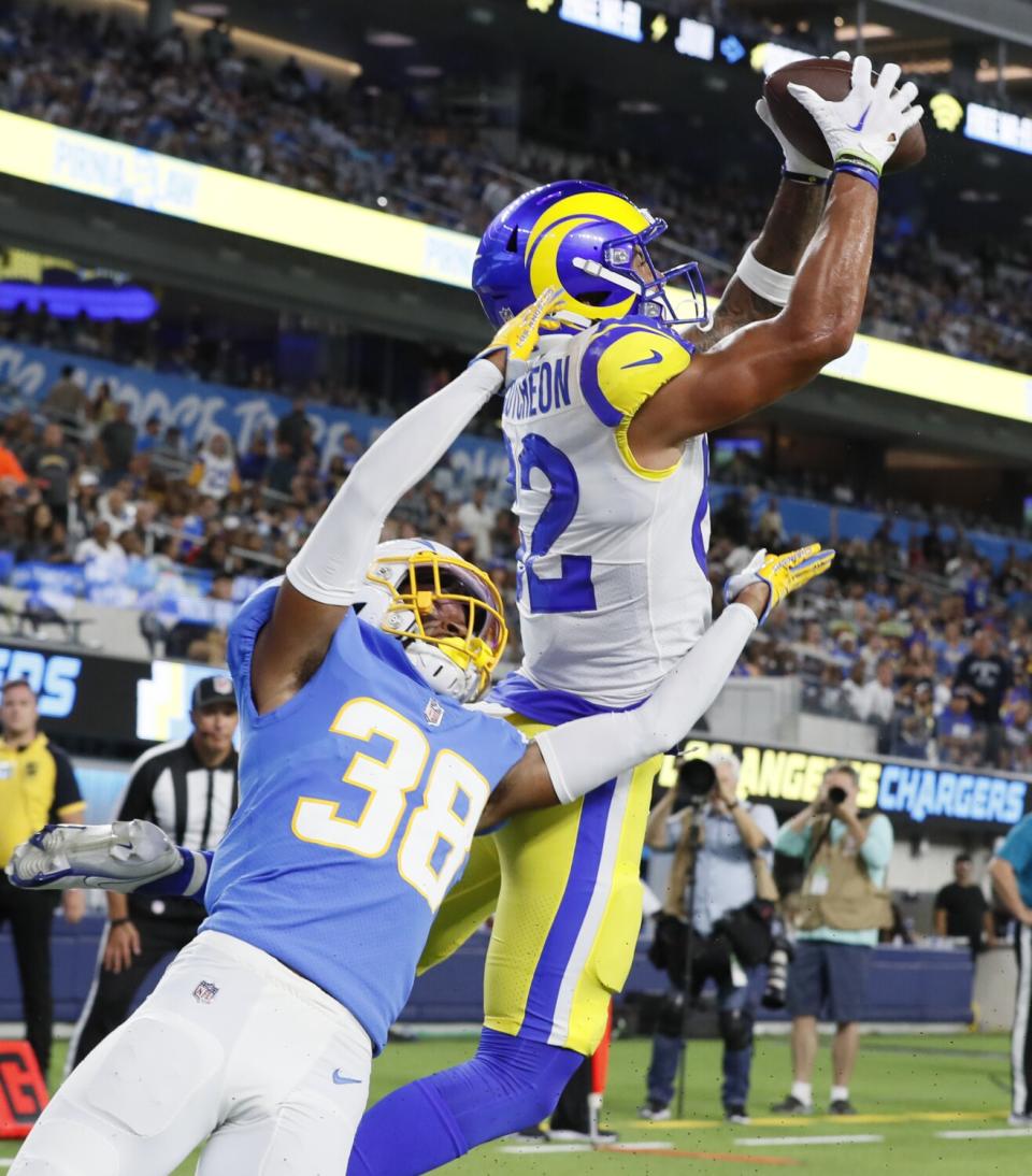 Rams wide receiver Lance McCutcheon catches a touchdown pass over Chargers cornerback Brandon Sebastian on Saturday.