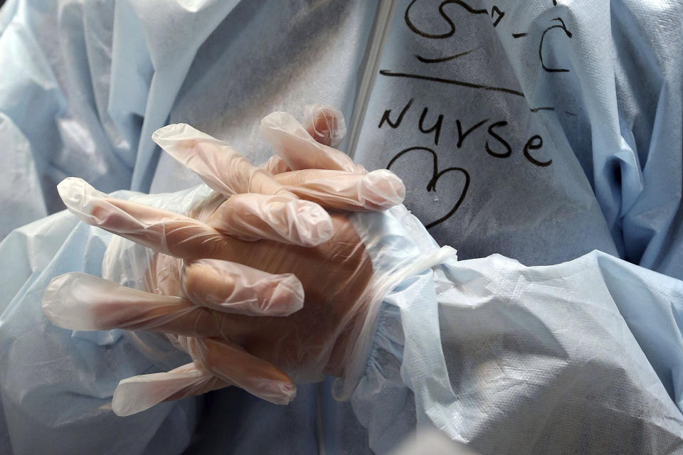 A nurse wears protective gear in a ward dedicated for people infected with the new coronavirus, at a hospital in Tehran, Iran, Sunday, March 8, 2020. With the approaching Persian New Year, known as Nowruz, officials kept up pressure on people not to travel and to stay home. Health Ministry spokesman Kianoush Jahanpour, who gave Iran's new casualty figures Sunday, reiterated that people should not even attend funerals. (AP Photo/Mohammad Ghadamali)