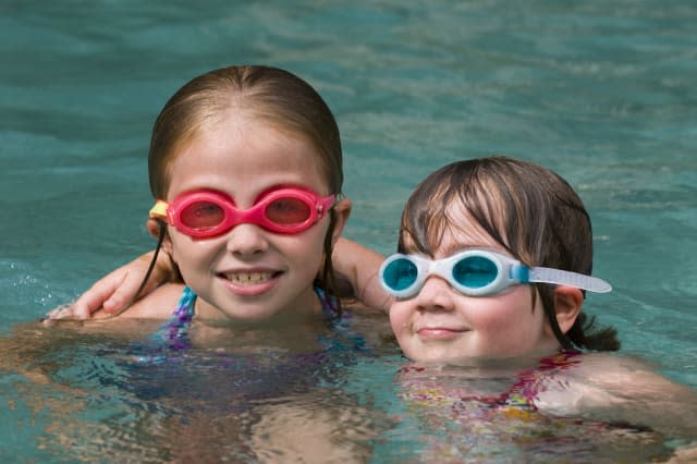 Two young girls having fun in pool