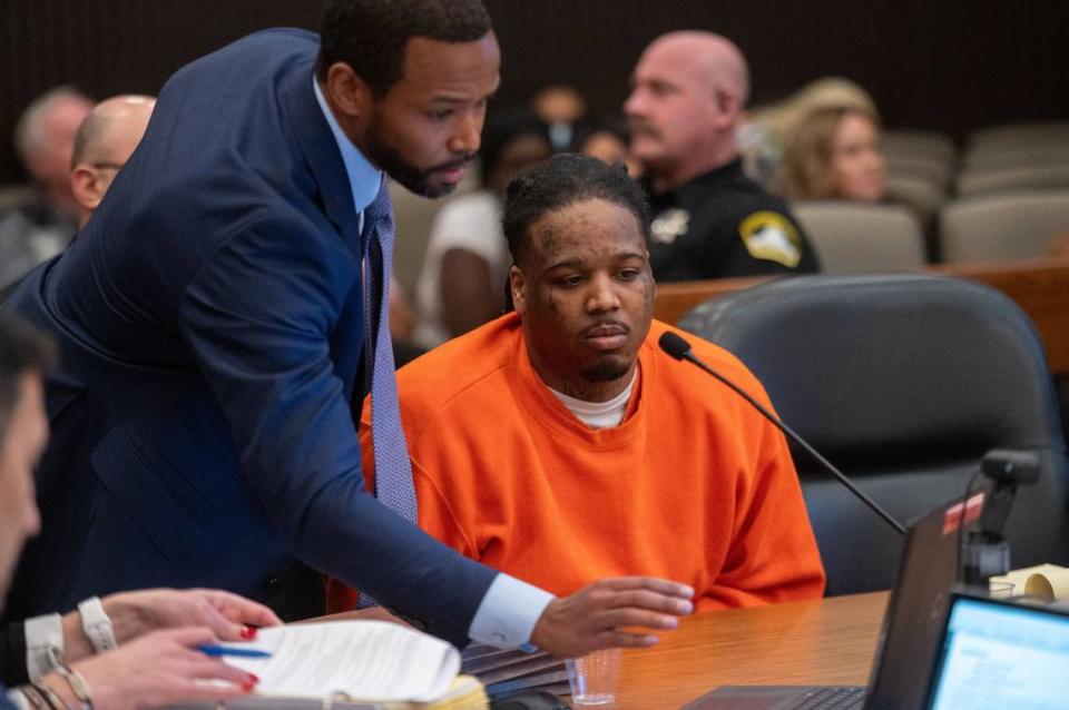 Murder suspect Smiley Martin, 23, looks at a video on a computer screen with his attorney Ray Thomas in Sacramento Superior Court on Friday, Jan. 19, 2024, during a preliminary hearing with two other suspects in the April 2022 downtown Sacramento mass shooting.