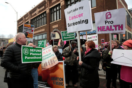 Supporters of Planned Parenthood (R) rally next to anti-abortion activists outside a Planned Parenthood clinic in Detroit, Michigan, U.S. February 11, 2017. REUTERS/Rebecca Cook