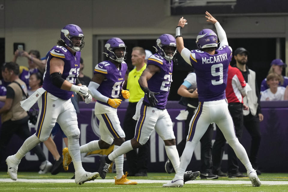 Minnesota Vikings quarterback J.J. McCarthy (9) celebrates with teammates after a touchdown against the Las Vegas Raiders during the first half of an NFL football game Saturday, Aug. 10, 2024, in Minneapolis. (AP Photo/Charlie Neibergall)