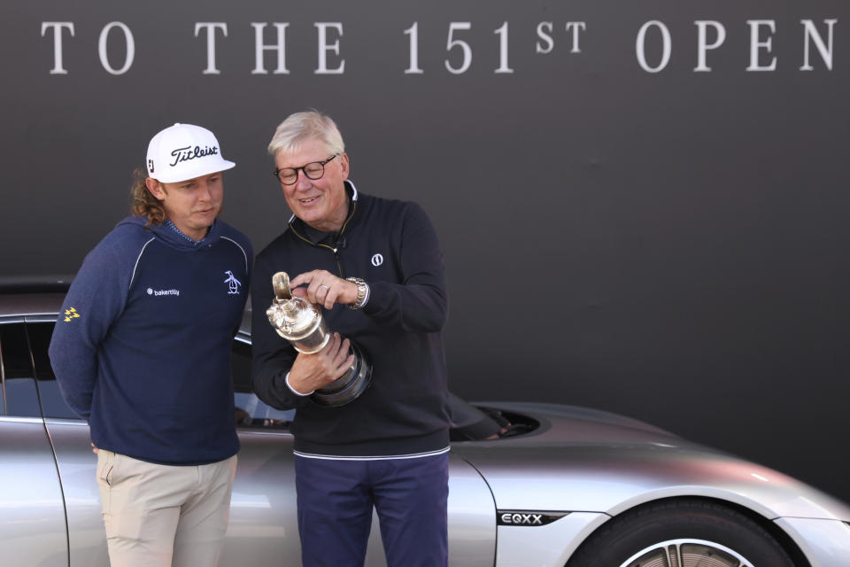 Martin Slumbers, right, the Chief Executive of The R&A and Secretary of The Royal and Ancient Golf Club St Andrews, holds and looks at the Claret Jug trophy that has just been handed back by Australia's Cameron Smith, winner of the 2022 British Open, at the Royal Liverpool Golf Club in Hoylake, England, Monday, July 17, 2023. The British Open Golf Championships starts Thursday, July 20. (AP Photo/Peter Morrison)