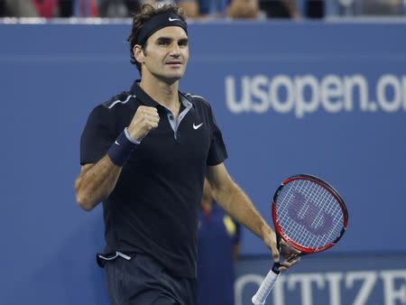 Roger Federer of Switzerland celebrates defeating Sam Groth of Australia in their men's singles match at the 2014 U.S. Open tennis tournament in New York, August 29, 2014. REUTERS/Shannon Stapleton