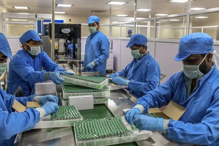 FILE -- Workers packing the Covishield coronavirus vaccine at the Serum Institute of India in Pune, Jan. 14, 2021. With its own battle against the coronavirus taking a sharp turn for the worse, India has severely curtailed exports of COVID-19 vaccines, triggering setbacks for vaccination drives in many other countries. (Atul Loke/The New York Times)