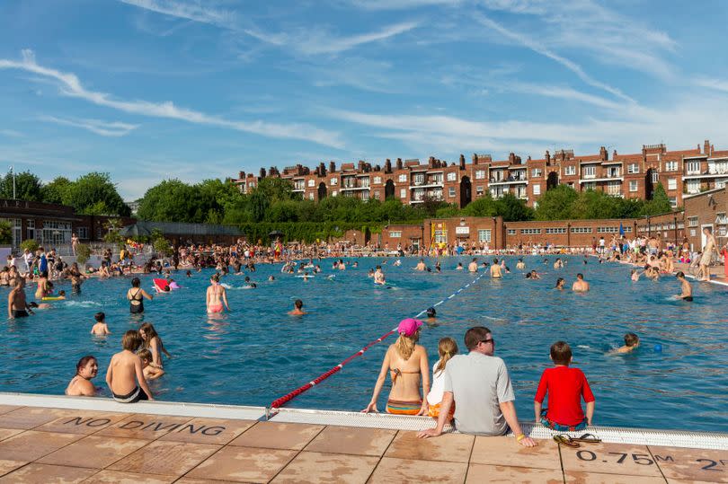 People swimming in Parliament Hill Lido, Hampstead, London in the sunshine