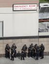 <p>Officials are gathered outside Bronx Lebanon Hospital Center after reports of a shooting, Friday, June 30, 2017, in New York. (AP Photo/Julio Cortez) </p>