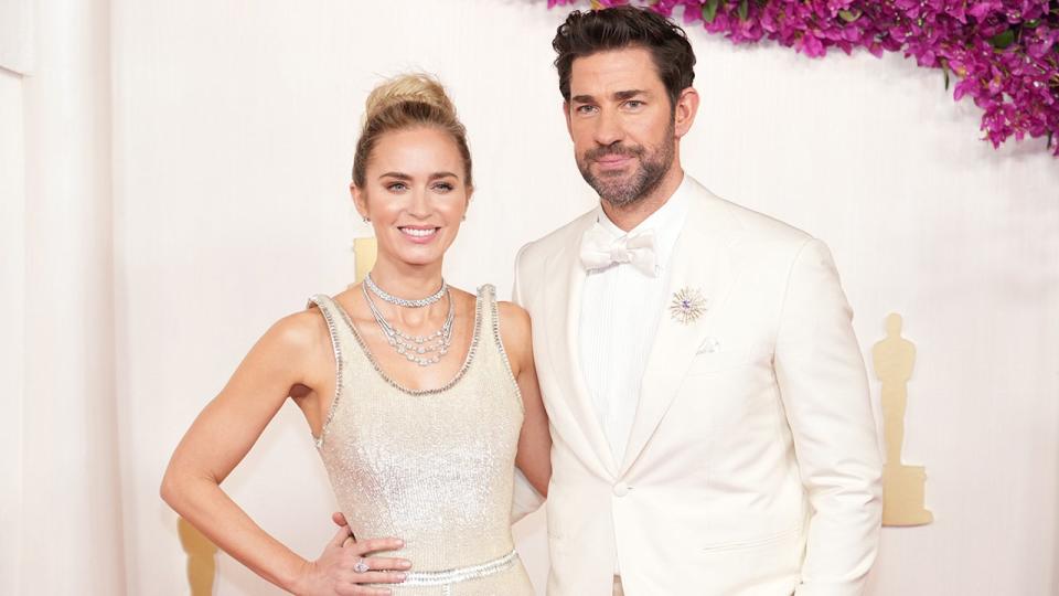 Emily Blunt in a white dress on the Oscars carpet with husband John Krasinski