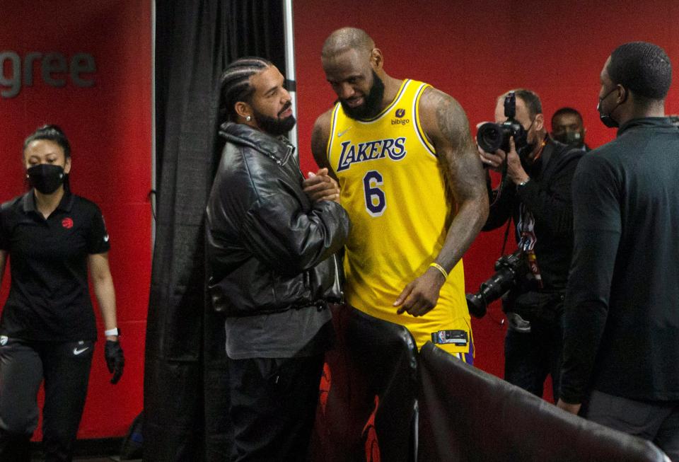 Los Angeles Lakers LeBron James greets Drake following an NBA basketball game against Toronto Raptors in Toronto on Friday, March 18, 2022. (Chris Young/The Canadian Press via AP)