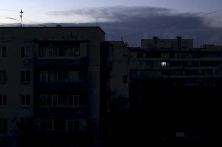 A single light illuminates a room during a blackout at a residential building in Yevpatoriya, Crimea, in this December 2, 2015 file photo. REUTERS/Pavel Rebrov/Files