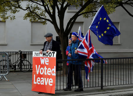 Pro-Brexit and anti-Brexit protesters hold posters and flags in Whitehall, in central London, Britain December 6, 2018. REUTERS/ Toby Melville