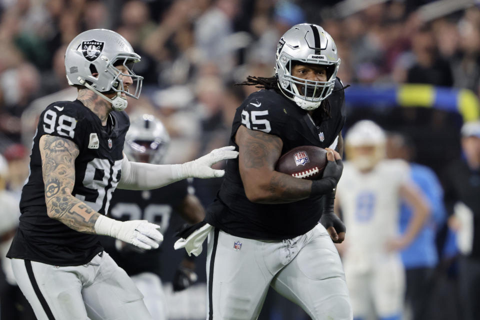 Las Vegas Raiders defensive tackle John Jenkins (95) runs for a touchdown after recovering a fumble by the Los Angeles Chargers during the second half of an NFL football game, Thursday, Dec. 14, 2023, in Las Vegas. (AP Photo/Steve Marcus)