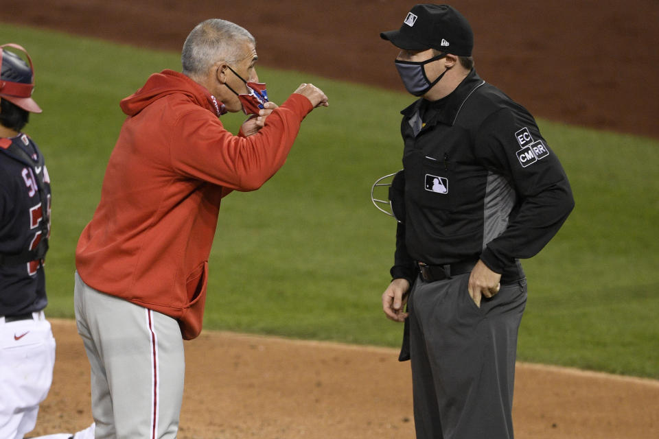 Philadelphia Phillies manager Joe Girardi, left, argues with home plate umpire Junior Valentine, right, after he was ejected during the third inning of a baseball game against the Washington Nationals, Monday, Sept. 21, 2020, in Washington. (AP Photo/Nick Wass)