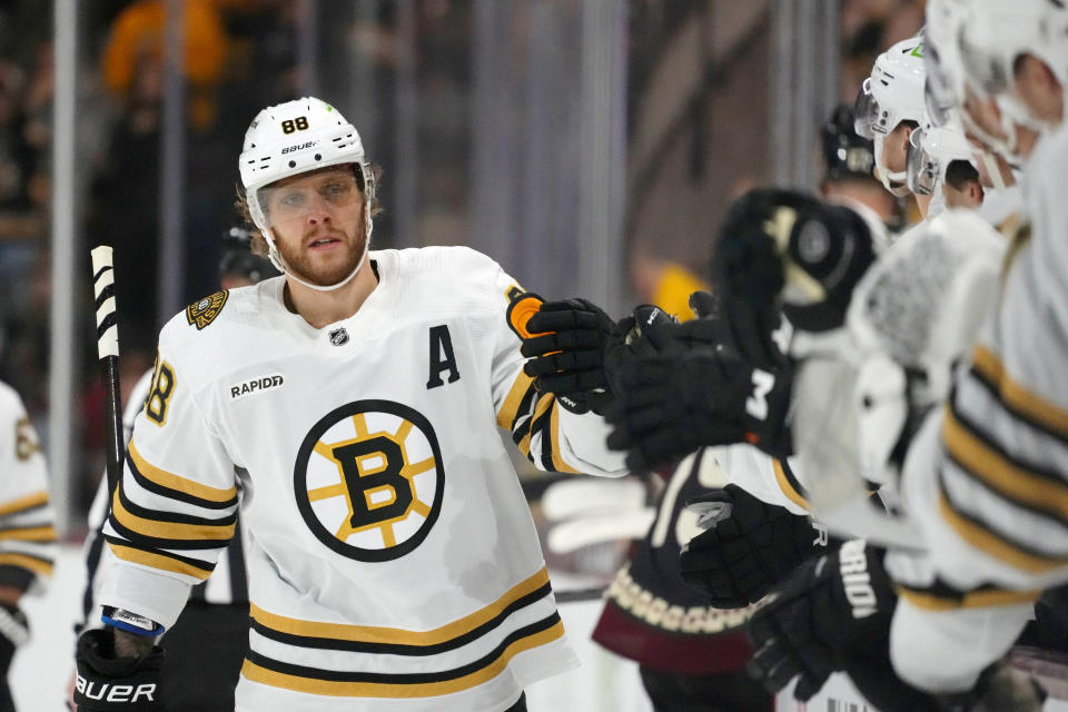 Boston Bruins right wing David Pastrnak (88) celebrates his goal against the Arizona Coyotes during the first period of an NHL hockey game Tuesday, Jan. 9, 2024, in Tempe, Ariz. (AP Photo/Ross D. Franklin)