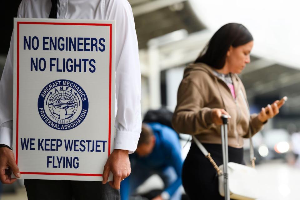 Striking aircraft mechanics are seen on the picket line at Pearson International Airport in Toronto on Saturday.