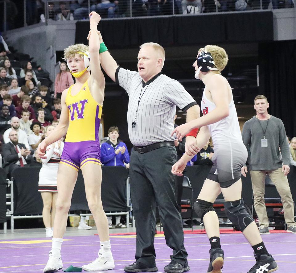 Watertown freshman Gage Lohr has his arm raised by the referee after he defeated Trevon Oehme of Brandon Valley (right) 6-5 in the Class A boys' 120-pound championship in the South Dakota State Individual Wrestling Tournament on Saturday, Feb. 24, 2024 in the Denny Sanford PREMIER Center at Sioux Falls. The title was the second in a row for Lohr, who finished 47-0.