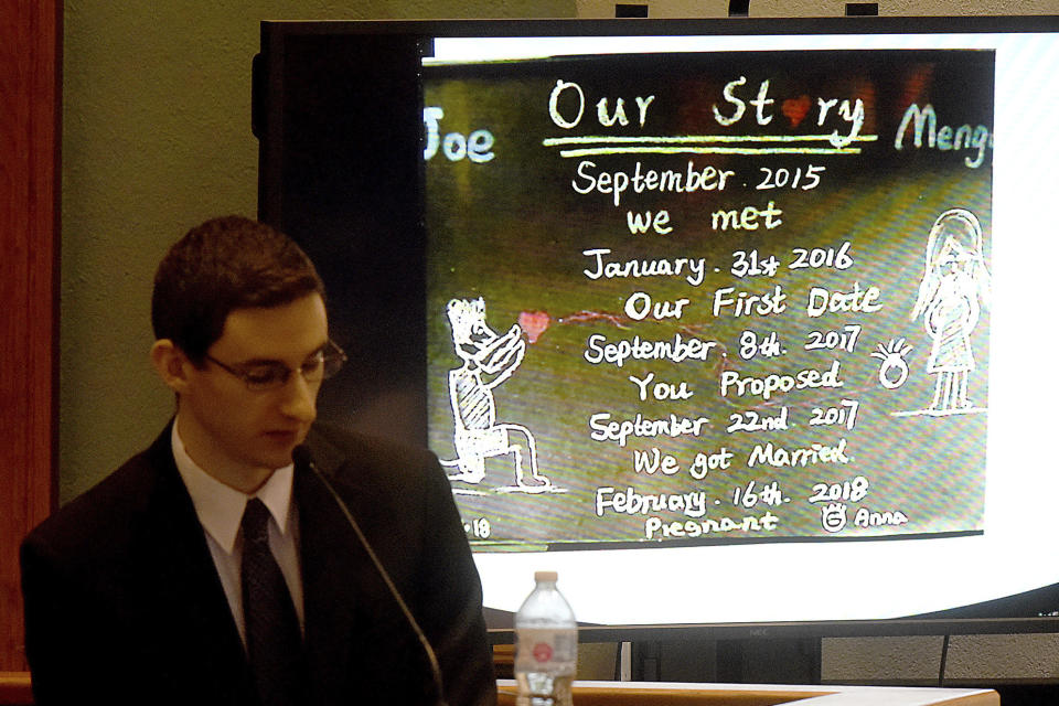 Defendant Joseph Elledge looks at a card that chronicles he and his wife Mungqi Ji's relationship and marriage during cross examination by Boone County Prosecuting Attorney Dan Knight during his murder trial Wednesday, Nov. 10, 2021, in Columbia, Mo. Elledge is accused of killing his 28-year-old wife Mengqi Ji, whom he reported missing in October 2019. Her remains were found in March in a park near Columbia, Mo. (Don Shrubshell/Columbia Daily Tribune via AP, Pool)