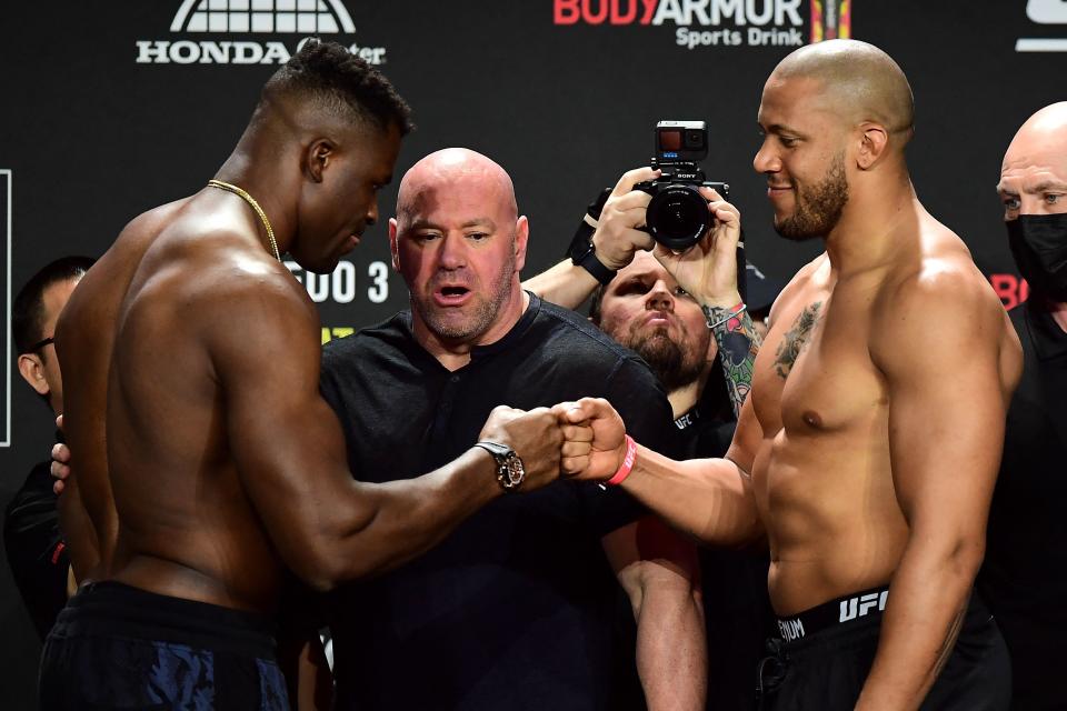 TOPSHOT - UFC 270 heavyweight world champion Cameroon&#39;s Francis Ngannou (L) and France&#39;s Ciryl Gane (R) bump fists as they weigh-in at the Anaheim Convention Center in Anaheim, California on January 21, 2022. (Photo by FREDERIC J. BROWN / AFP) (Photo by FREDERIC J. BROWN/AFP via Getty Images)