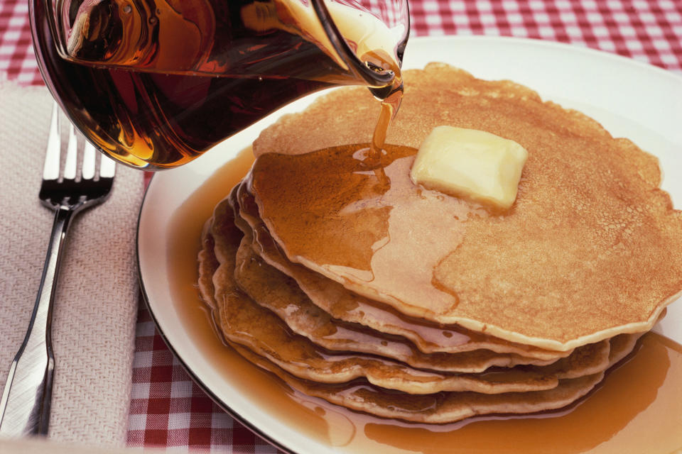 a stack of pancakes with butter and syrup