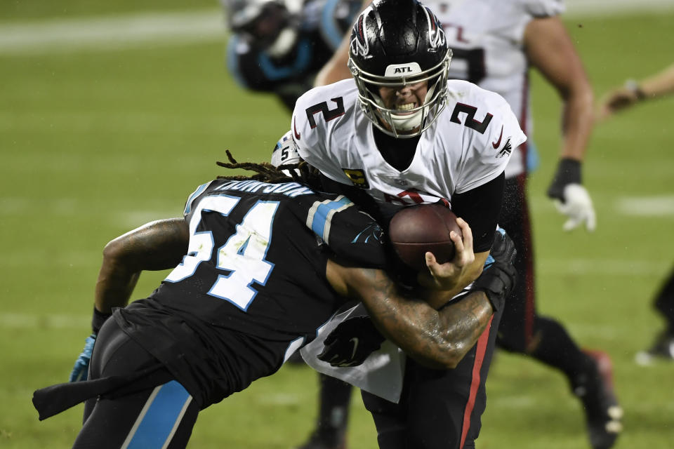 Atlanta Falcons quarterback Matt Ryan gets sacked by Atlanta Falcons linebacker Foye Oluokun during the first half of an NFL football game Thursday, Oct. 29, 2020, in Charlotte, N.C. (AP Photo/Mike McCarn)