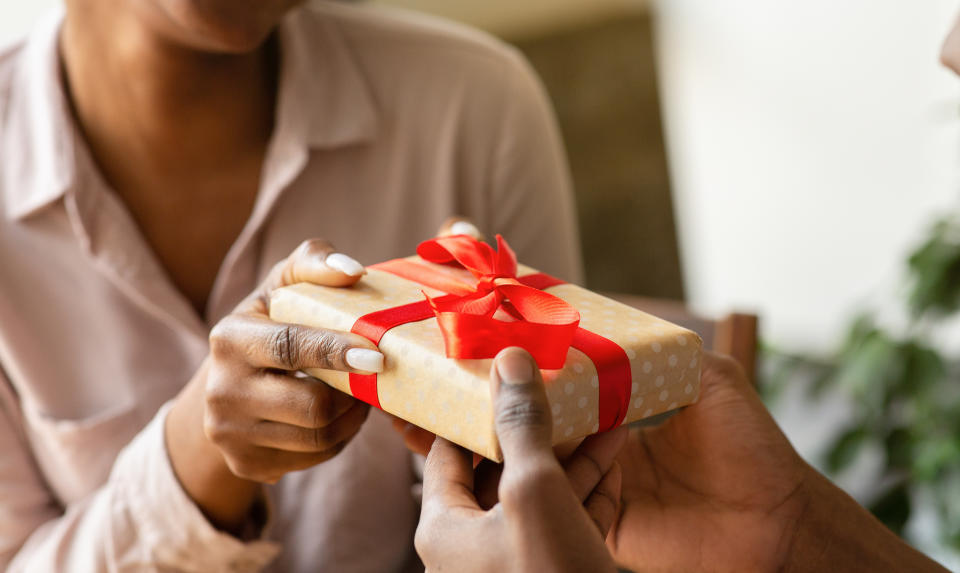 giving his girlfriend gift at cafe