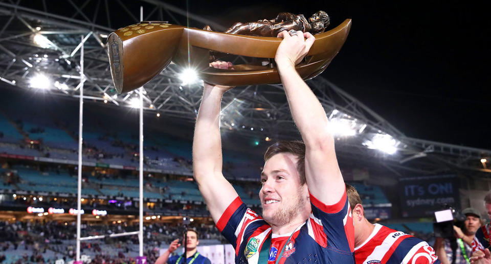Luke Keary hoists the NRL trophy aloft after the Roosters' win in the 2018 premiership. Pic: Getty