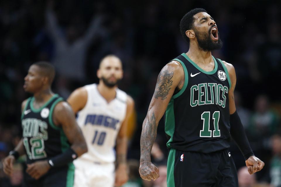 Boston Celtics' Kyrie Irving (11) celebrates as the team rallies against the Orlando Magic during the second half of an NBA basketball game in Boston, Sunday, April 7, 2019. (AP Photo/Michael Dwyer)