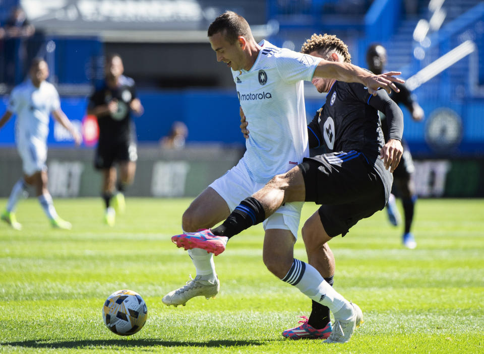 CF Montreal's Zorhan Bassong, right, challenges Chicago Fire FC's Boris Sekulic during first half MLS soccer action in Montreal, Sunday, Sept. 19, 2021. (Graham Hughes/The Canadian Press via AP)